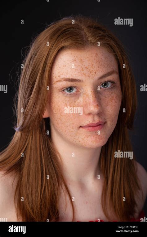 Portrait Of A Pretty Teenage Girl With Red Hair And Freckles Looking