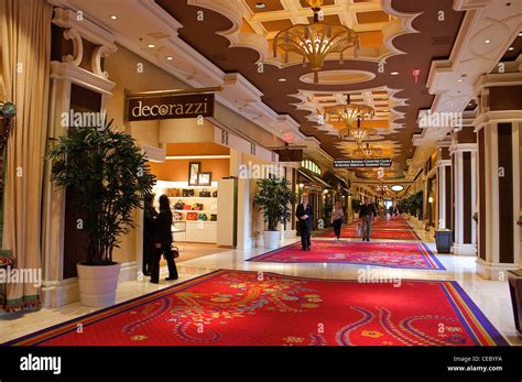 People Walk Through An Elegant Hall Lined With Shops Inside The Wynn