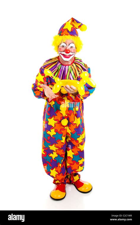 Full body isolated view of a birthday clown holding a balloon animal ...