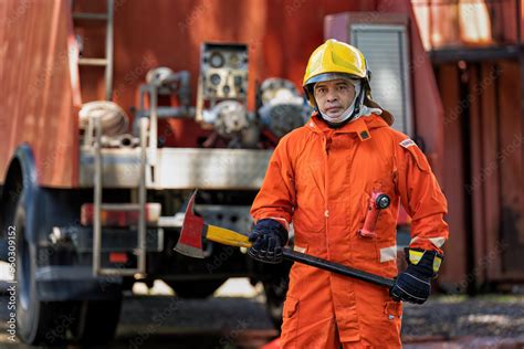 Fireman Wearing Fire Protection Suite And Oxygen Tank Exercise Hold Axe