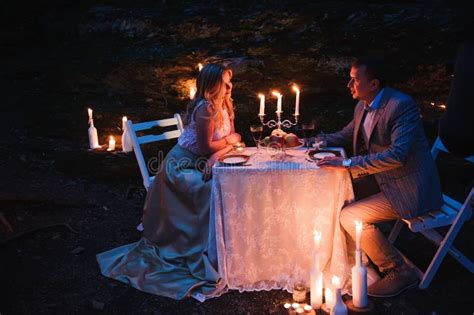 Romantic Couple Together Over Candlelight During Romantic Dinner