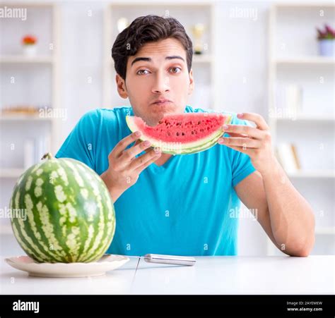 Man Eating Watermelon At Home Stock Photo Alamy