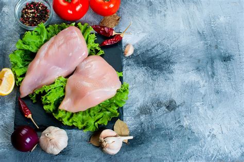 Raw Chicken Fillet On Cutting Board With Spices And Herbs Stock Image