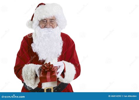 Studio Shot Of Santa Claus Holding T Wrapped Present Stock Photo