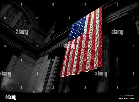 American flag hangs in large building Stock Photo - Alamy