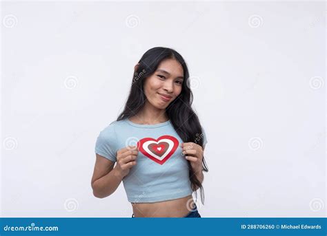 A Happy And Upbeat Trans Woman Showing Off A Heart Shape On Her T Shirt