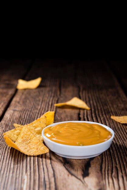 Premium Photo | Nachos with cheese sauce