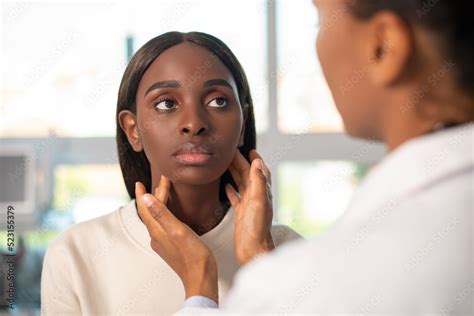 Serious African American Woman Having Medical Exam In Clinic