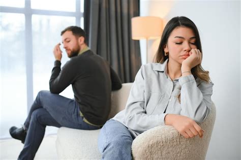 Premium Photo Beautiful Couple Is Sitting Back To Back On The Couch