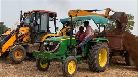 Jcb Dx Machine Loading Mud In Mahindra Tractor And John Deere Tractor