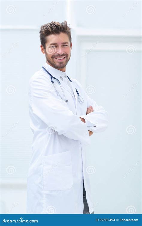 Portrait Of Confident Male Doctor With Arms Crossed Standing Stock