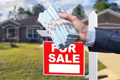 Buyer Handing Over Cash For House With Home And For Sale Real Estate