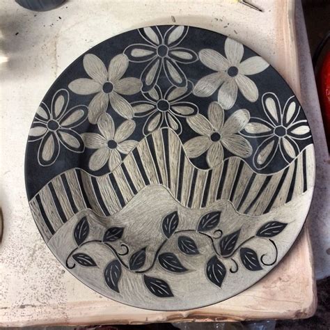 a black and white plate with flowers on it