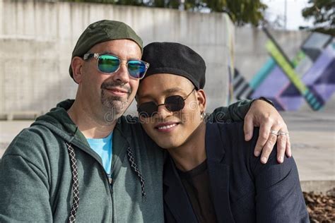 Gay Male Couple Hugging And Looking At Camera Stock Image Image Of Friends Outside
