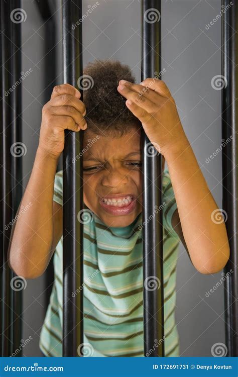 Kid Prisoner Try To Escape from Jail. Stock Image - Image of escape ...