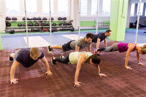 Group Of People Doing Push Ups In Gym Stock Photo Image Of Person