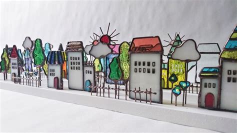 This Is An Image Of A City Scene Made Out Of Stained Glass And Paper Machs