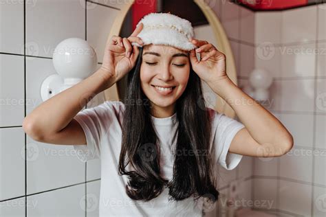 Portrait Of Beautiful Asian Girl In White T Shirt And Sleeping Mask Posing In Bathroom 12905274