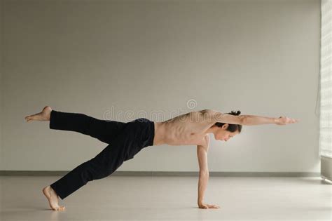 A Man With A Naked Torso Does Yoga In The Gym The Concept Of A Healthy Lifestyle Stock Photo