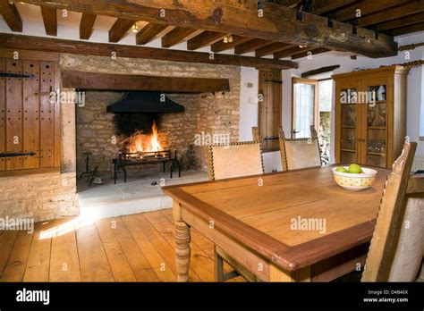 An Arts And Crafts Style Cottage Dining Room With A Large Fireplace