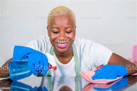 Young Beautiful And Happy African American Black Woman In Washing Rubber Clothes Cleaning Home