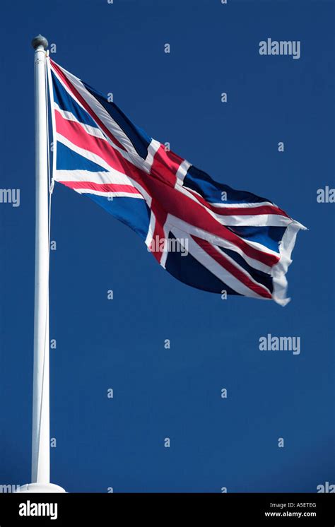 Union Jack Flag Flying Against Blue Sky Stock Photo Alamy