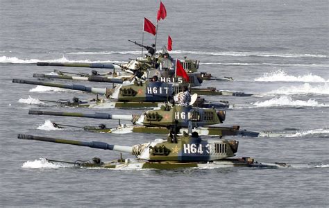 Amphibious tanks of the Chinese People's Liberation Army move to land a ...