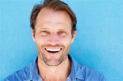 Premium Photo Close Up Attractive Male Model Smiling Against Blue Wall