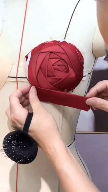 A Woman Is Working On A Piece Of Art That Looks Like A Rose With Spikes