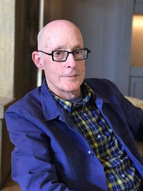 Premium Photo Portrait Of Senior Bald Man Wearing Sunglasses While Sitting On Chair