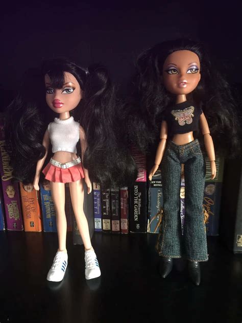 Download Two Dolls Standing Next To Each Other