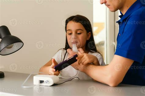 Father And Daughter Do Inhalations Caring Dad Helps Her Daughter