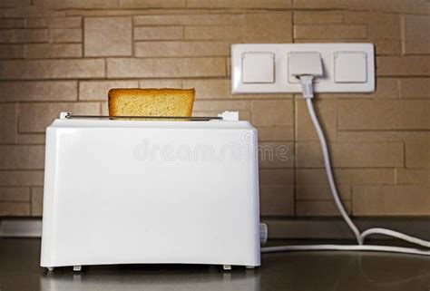 White Toaster With Toasted Slice Of Bread In The Kitchen Horizontal