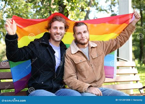 Gay Couple With Rainbow Wristbands And Hand Heart Stock Image