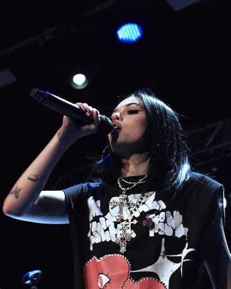 A Woman Singing Into A Microphone On Stage