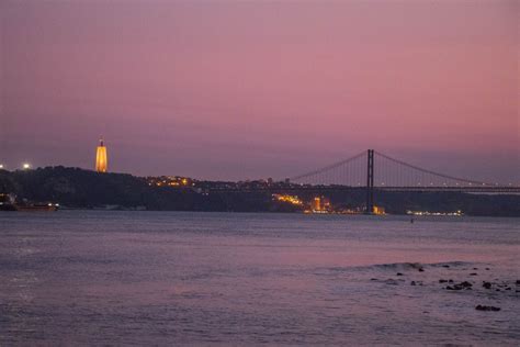 Aerial View From Behind Of The Cristo Rei Monument With Ponte 25 De