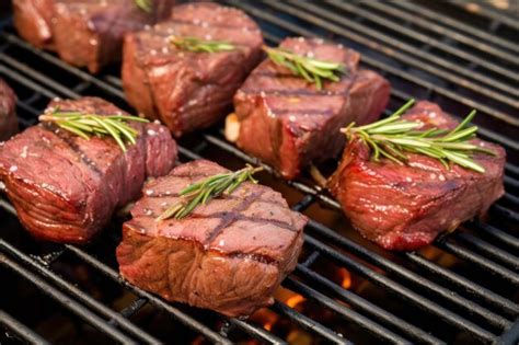 Premium AI Image | Bbq steak tips on a grill with garlic and rosemary