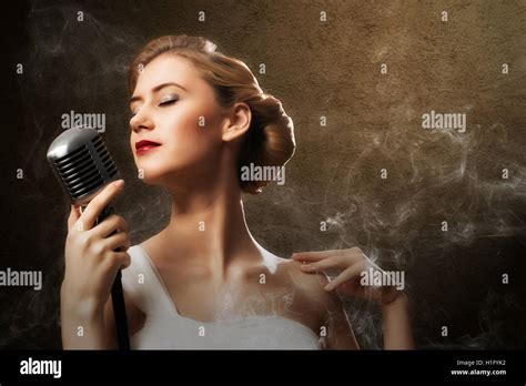 Beautiful Blonde Woman Singer With A Microphone Stock Photo Alamy