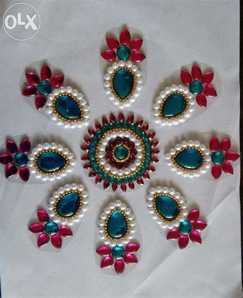 A White Table Cloth With Red Green And Blue Decorations In The Center