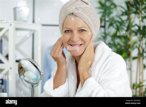 Mature Woman Performing Her Skincare Routine Stock Photo Alamy