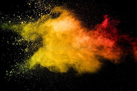 Abstract Yellow Orange Powder Explosion On Black Background Freeze