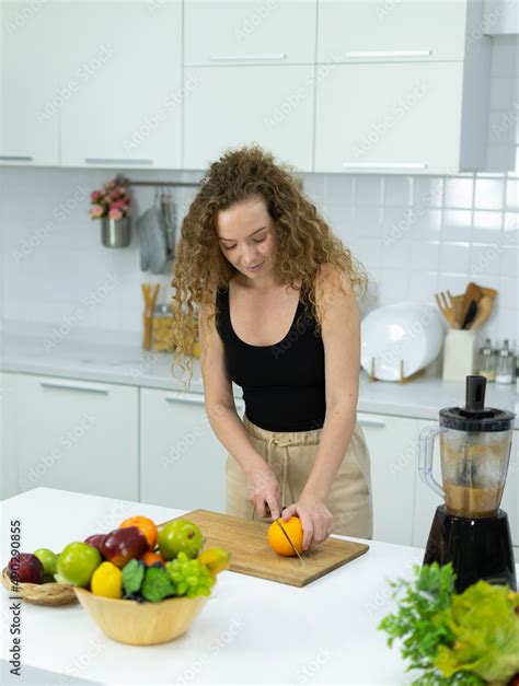 Smart Vegetarian Woman Cut Orange For Mixing Healthy Vegetable And