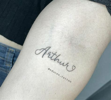 A Woman S Arm With The Word Arthrut Written In Cursive Font