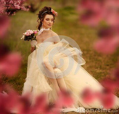 Sexy Blonde Like A Doll In The Bathroom On A Gold Background In Gold Dress Stock Photo