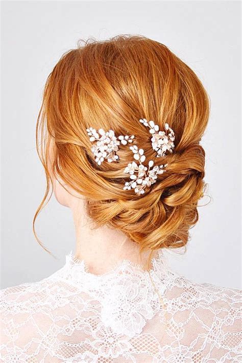 A Woman With Red Hair Is Wearing A White Dress And Some Flowers In Her Hair