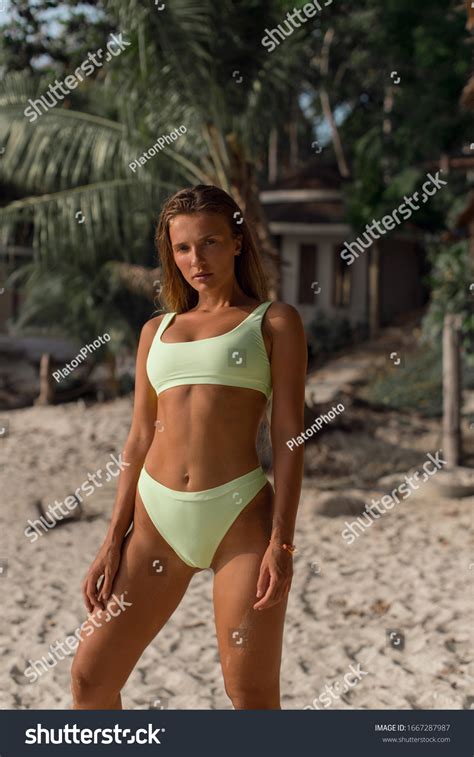 Sexy Tanned Brunette Green Swimsuit Posing Stock Photo