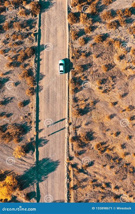 Overhead Aerial Drone Shot of a Narrow Desert Road with a Car on the Side of the Road Stock ...