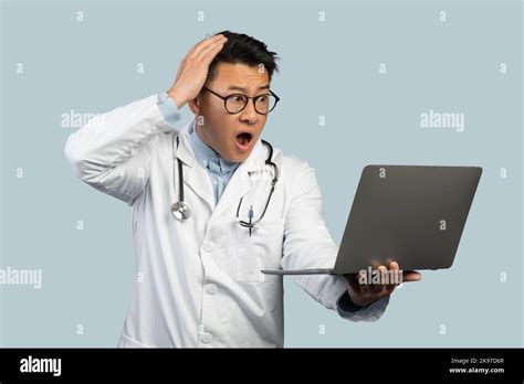 Sad Shocked Mature Chinese Man Doctor In White Coat Glasses With
