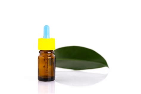 Premium Photo Blank Amber Glass Essential Oil Bottle With Pipette On