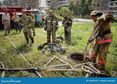 Firefighters With The Inscription On The Back In Russian `fire